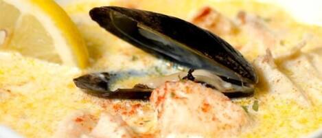 A seafood dish with mussels and lemon slices.