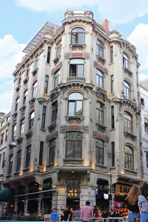 A historic building with ornate architectural details, multiple balconies, and large windows. - Ragıp Pasha Apartments (Istanbul)