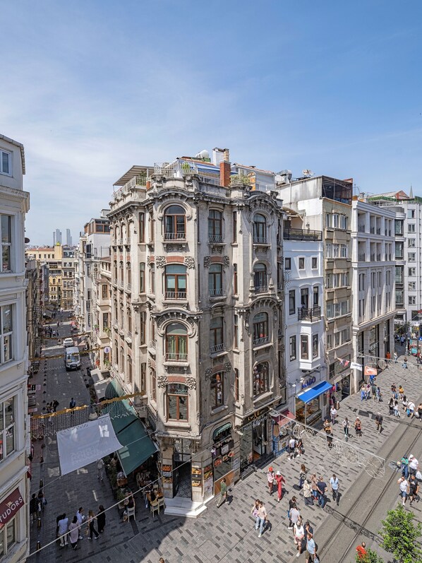 A historic building with ornate architecture, a central courtyard, and a bustling street scene. - Ragıp Pasha Apartments (Istanbul)