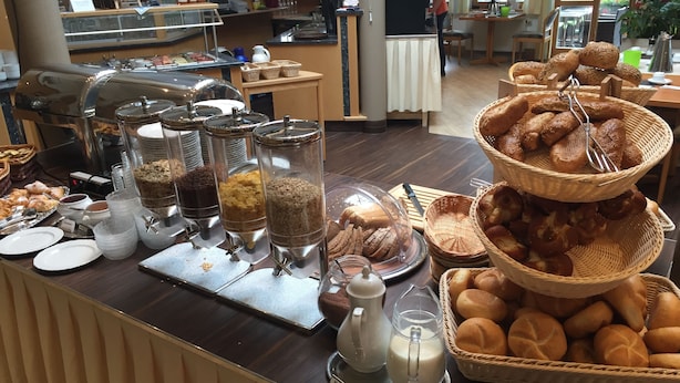 A buffet area with various food items, including pastries, bread, and condiments. - Hotel Bayerischer Wald (Neukirchen)
