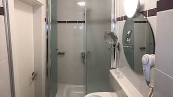 A bathroom with a glass-enclosed shower, a sink with a mirror, and a hairdryer on the wall.