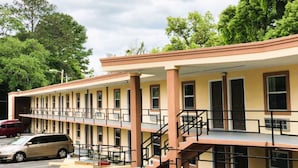 A multi-story motel with a flat roof, multiple balconies, and a parking lot. - OYO Hotel Tallahassee Downtown (Tallahassee)