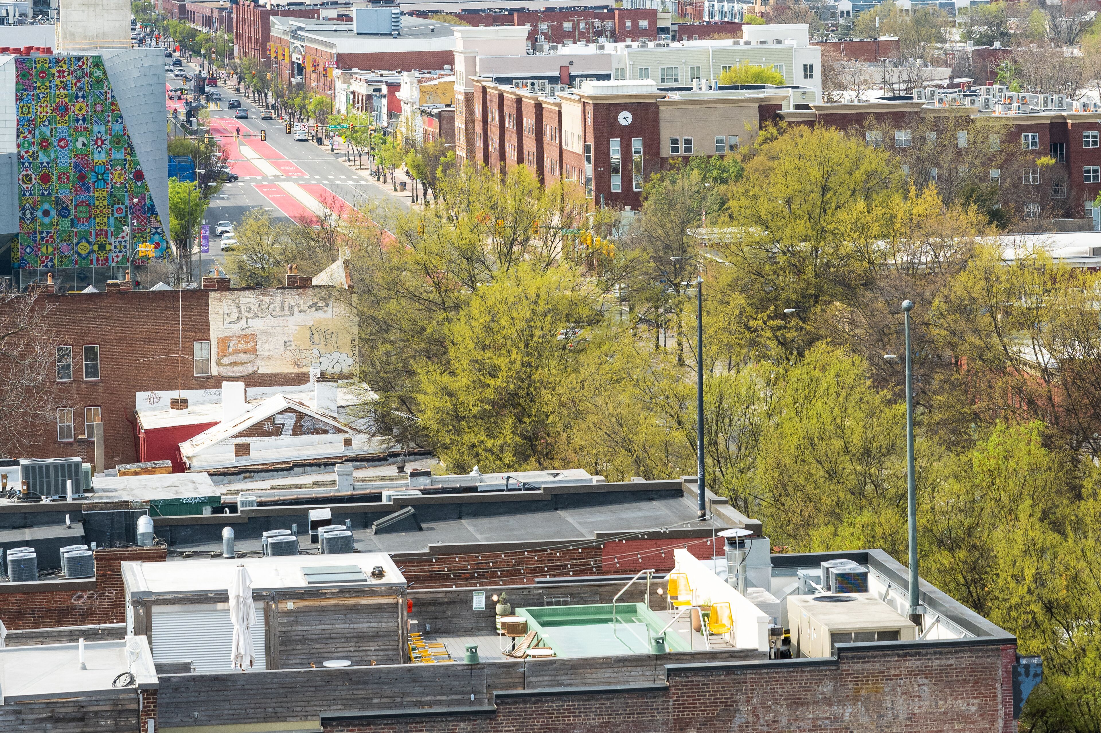 A cityscape with buildings, trees, and a road.
