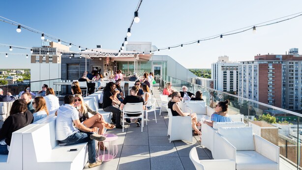 A rooftop terrace with outdoor seating and string lights. - Quirk Hotel Richmond (Richmond)