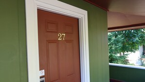 A brown door with the number 27, a white door frame, and a green wall. - Mountain View Lodge (Packwood)