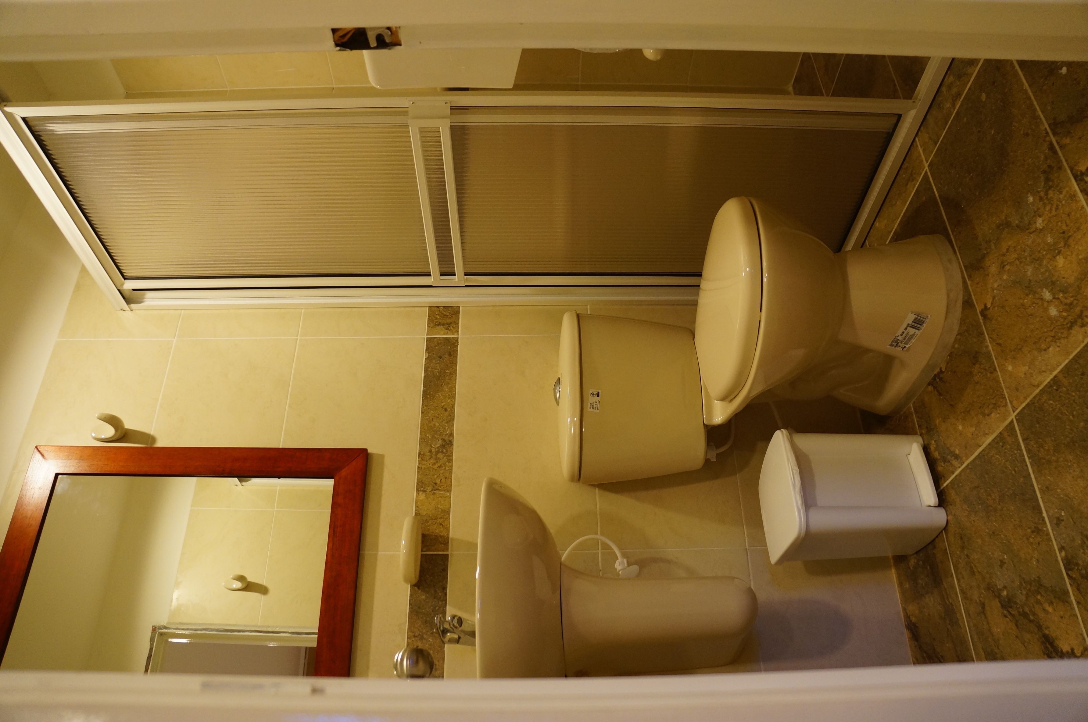 A bathroom with a toilet, bidet, and sink.