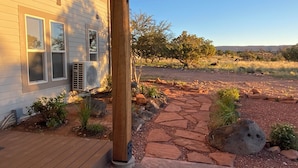 A house with a stone pathway leading to a wooden deck.