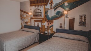 A room with two beds, a nightstand, and a mural of a village scene. - Hotel Aurora (Oaxaca)