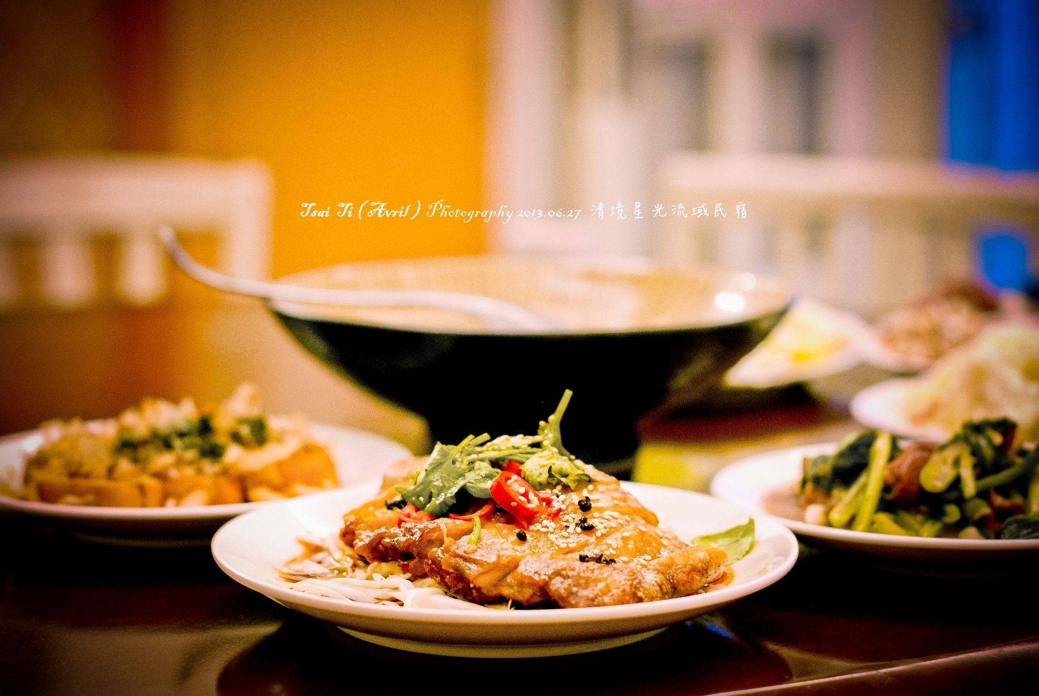 A dining table with various dishes, including a main dish with vegetables and a side salad.