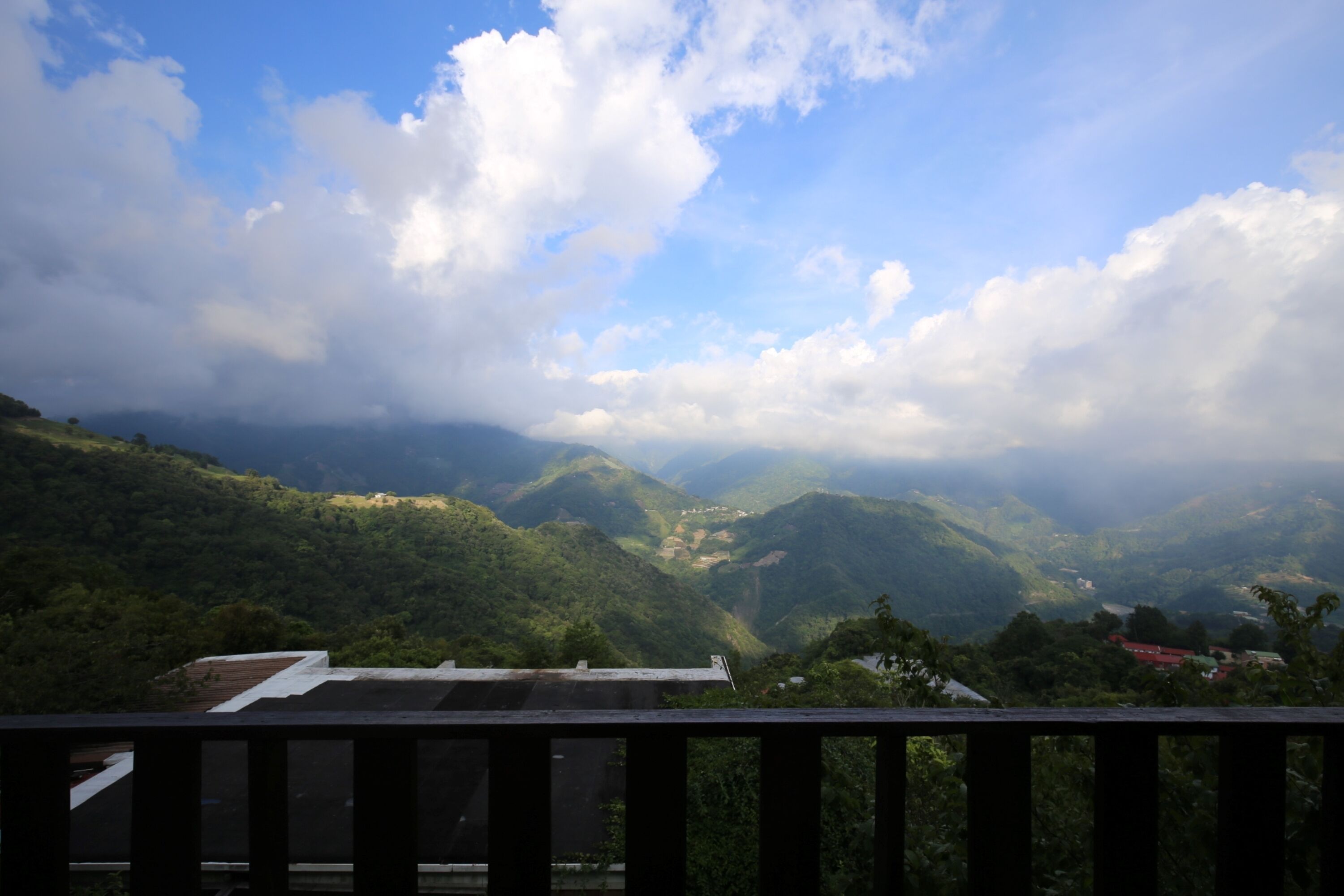 A mountainous landscape with a view of the sky and clouds.
