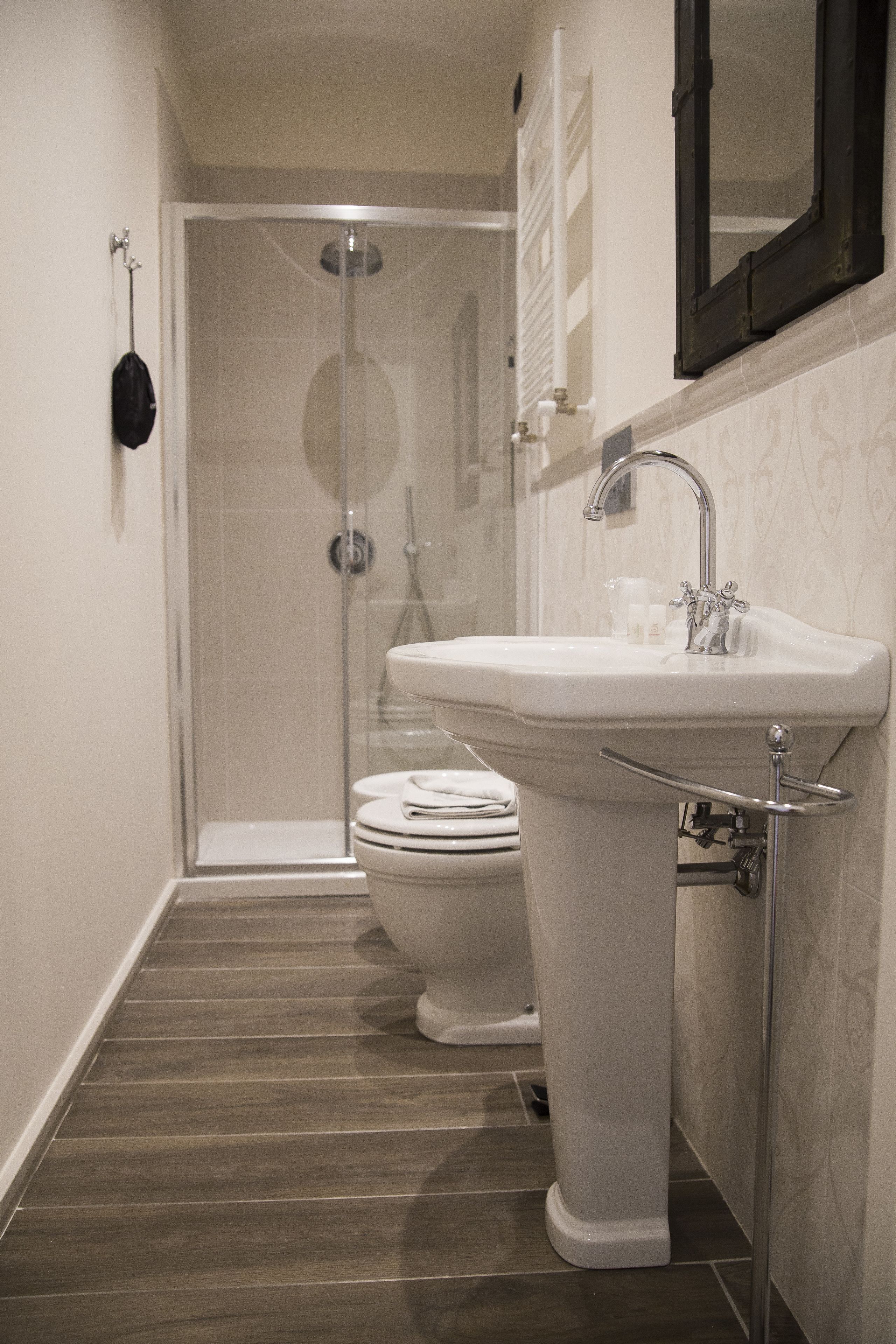A bathroom with a shower, toilet, and sink.