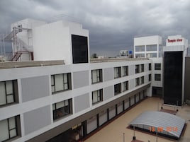 A multi-story building with a modern architectural design, featuring a prominent 'Temple View' sign on the top right.
