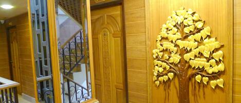 A wooden wall with a tree relief and a door labeled "406".