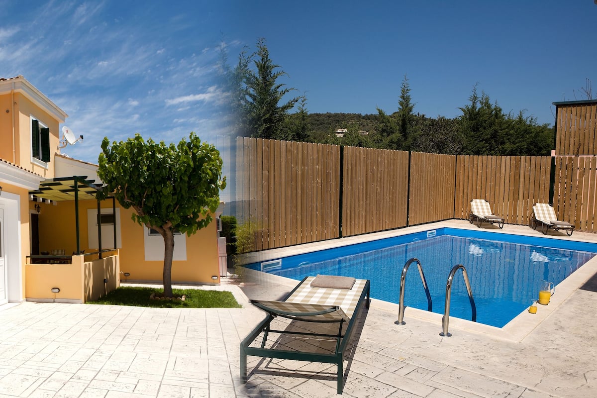 Zona de piscina con piscina, sillones reclinables y una pequeña mesa.