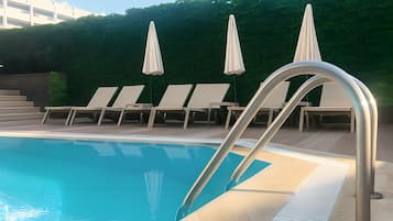Seasonal outdoor pool, open 10:00 AM to 8:00 PM, pool umbrellas