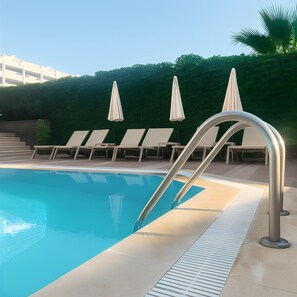 Seasonal outdoor pool, open 10:00 AM to 8:00 PM, pool umbrellas