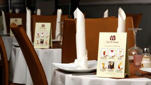 A restaurant setting with tables set for dining, featuring menus and cutlery. - The W Hotel (Lagos)