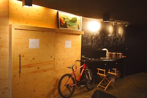 A wooden room with a bicycle, a desk, and a chair. - C40Winks Hostel (Bangkok)