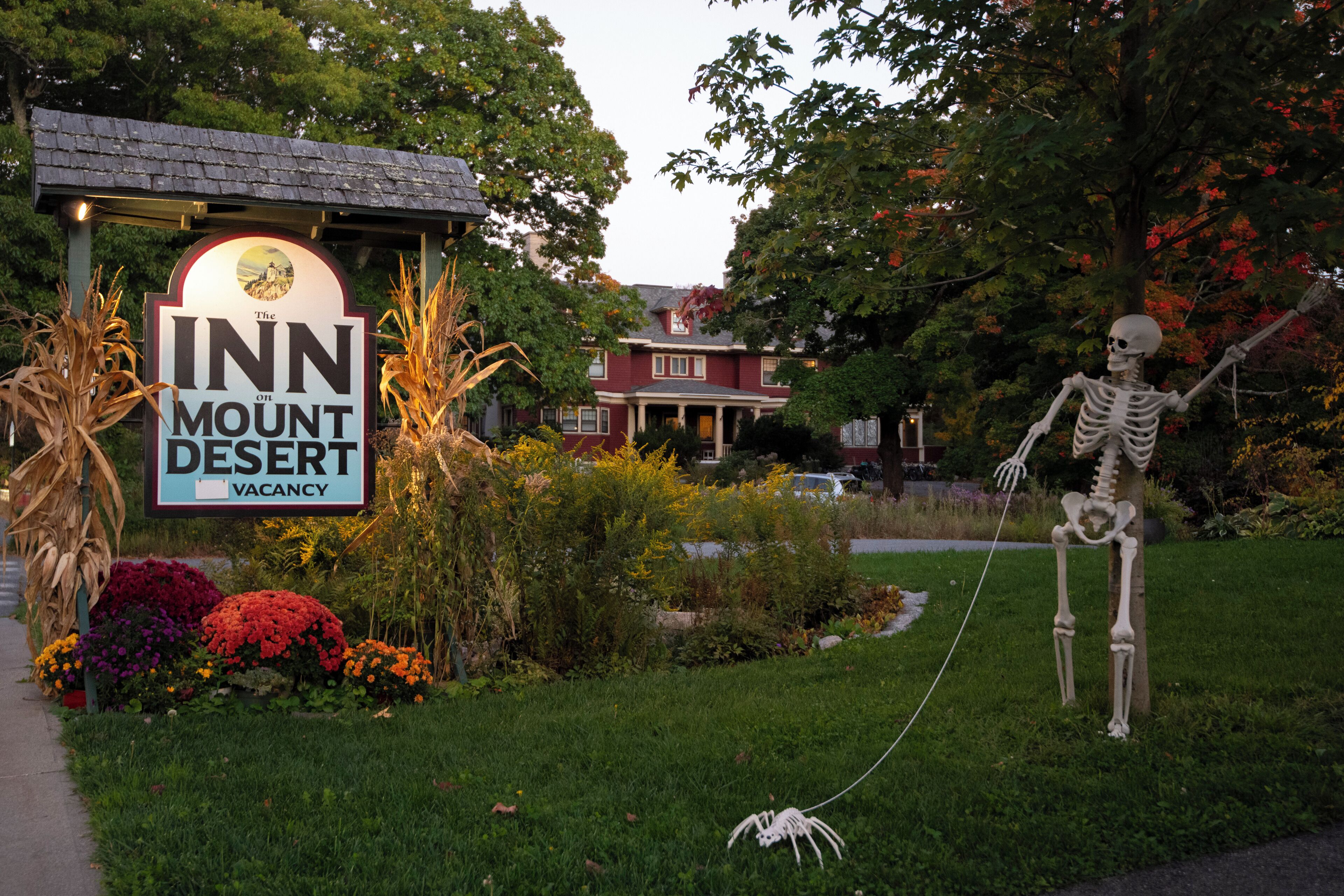 A sign for 'The Inn on Mount Desert' with a skeleton decoration.