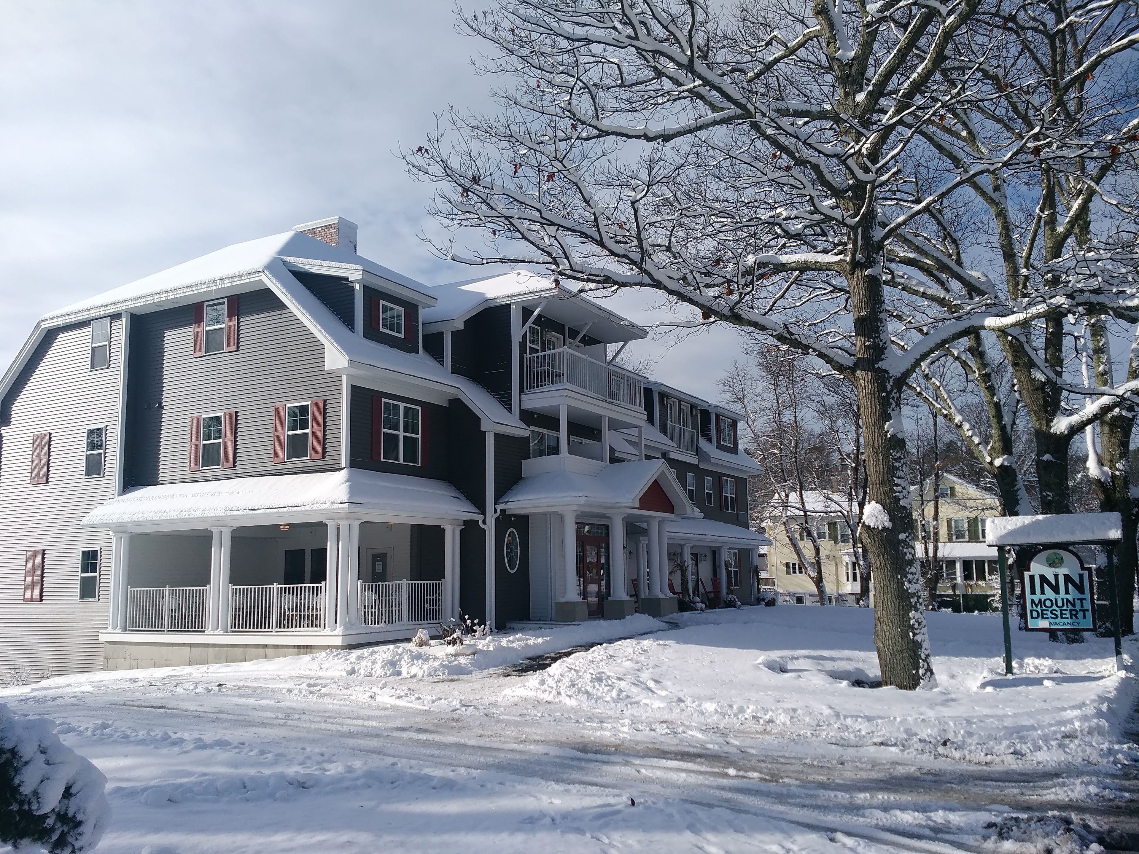 A two-story building with a porch and a sign indicating it is an inn.
