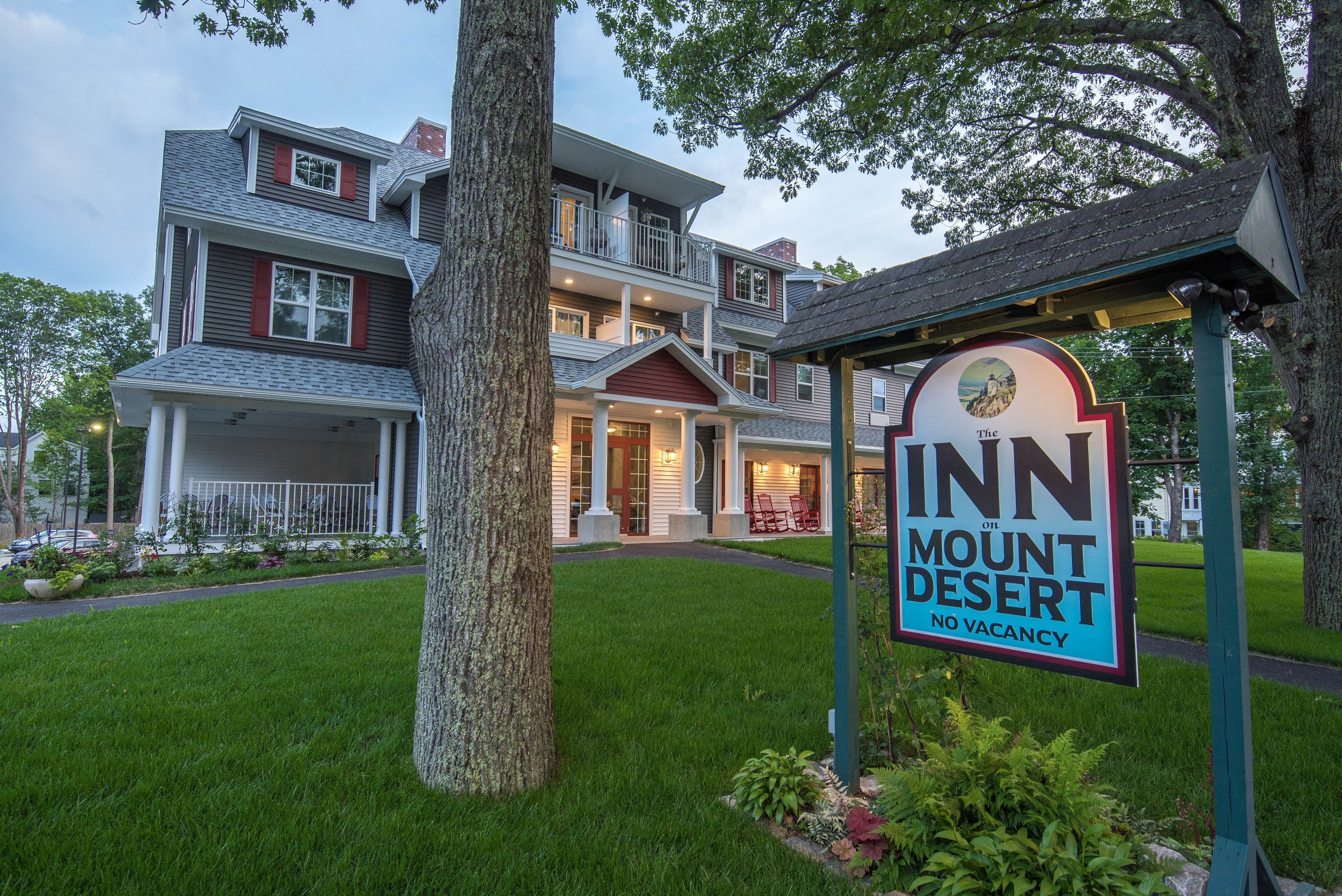 A two-story hotel with a sign indicating no vacancy.