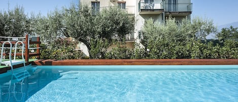 Seasonal outdoor pool, pool umbrellas, pool loungers