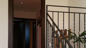 A staircase with a black metal railing leading to an interior space. - B&B Anthea dell'Etna (Santa Venerina)