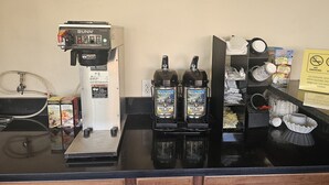 A coffee station with a Bunn coffee machine, two Mountain Roast coffee dispensers, and a sign for Gold Bean Coffee. - Redrock Country Inn (Kanab)