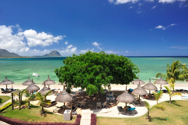 On the beach, white sand, sun-loungers, beach umbrellas