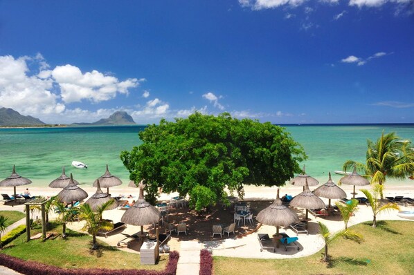 On the beach, white sand, sun loungers, beach umbrellas