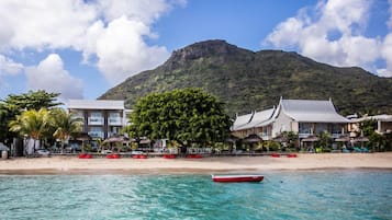 On the beach, white sand, sun loungers, beach umbrellas