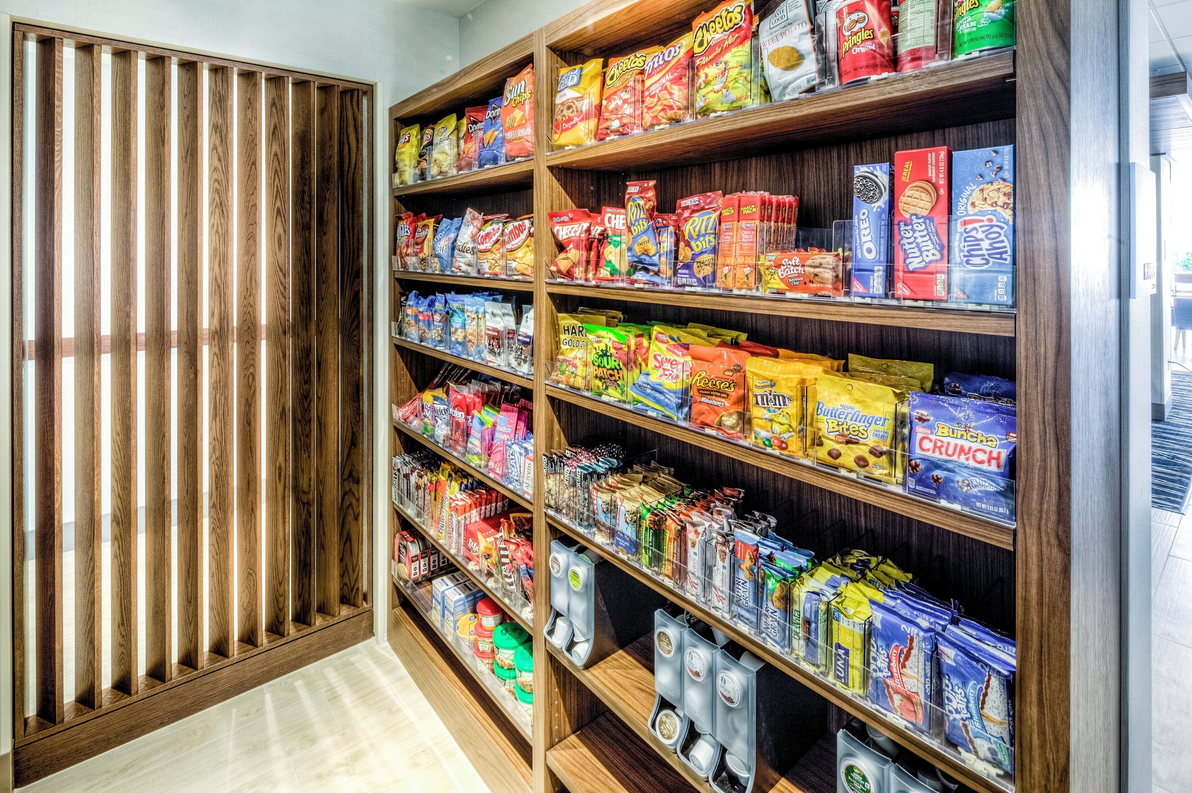 A snack aisle with various packaged snacks and beverages.