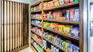 A snack aisle with various packaged snacks and beverages.