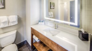 A bathroom with a white sink, a mirror, and a towel rack. - Holiday Inn Express & Suites Cleveland West - Westlake by IHG (Westlake)