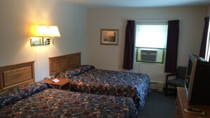 A hotel room with two beds, a desk, a chair, a television, and a window with curtains. - Fern Ridge Motel (Blakeslee)