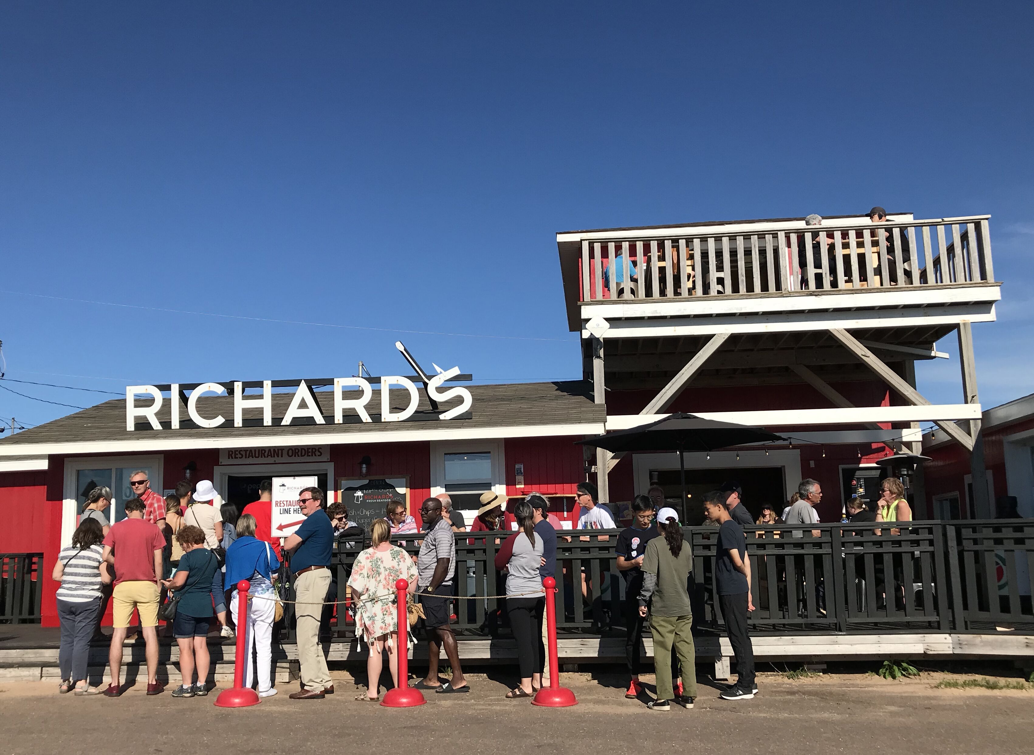 A restaurant named 'RICHARDS' with a red exterior and a balcony.