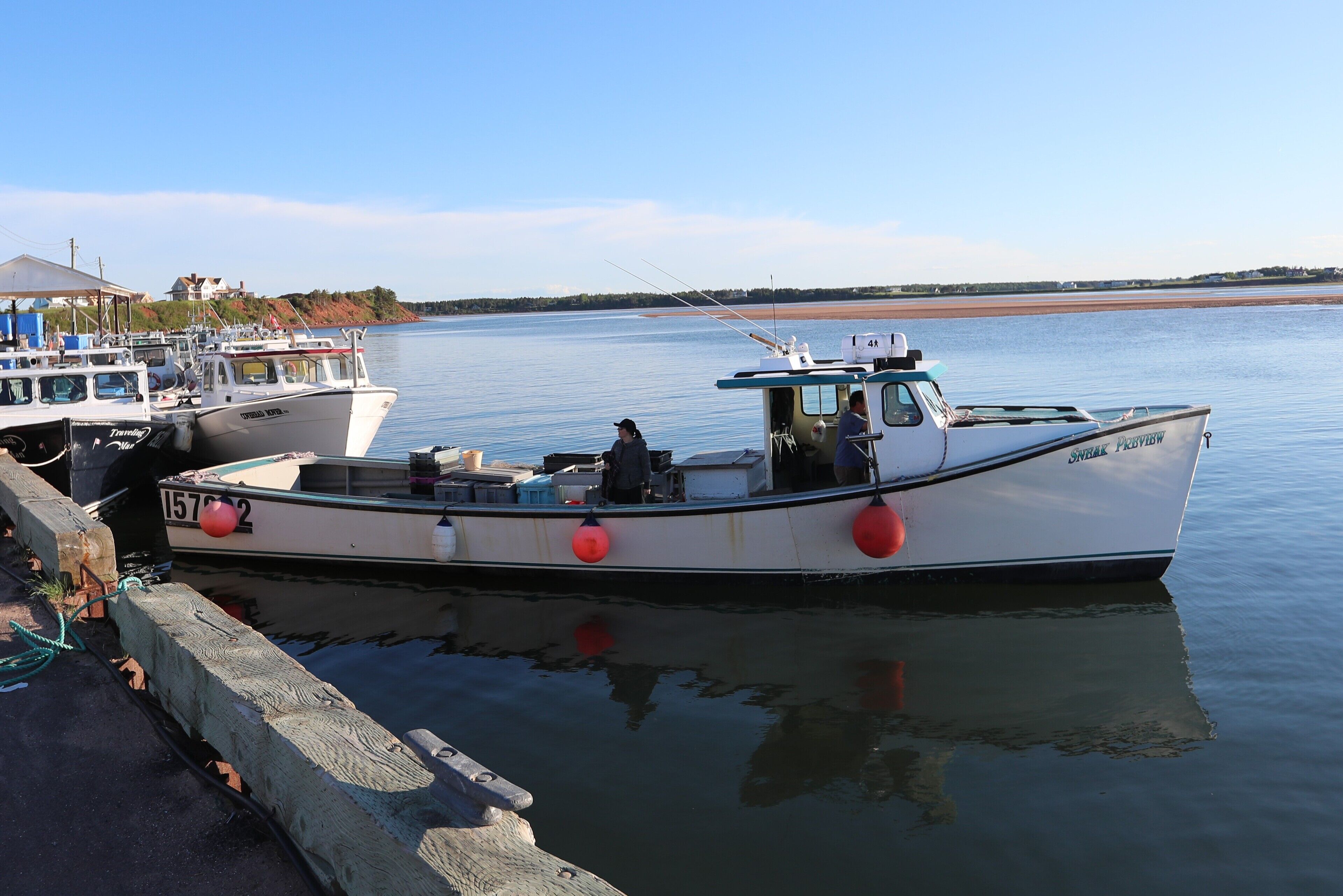 A docked boat with a cabin and a small deck area.