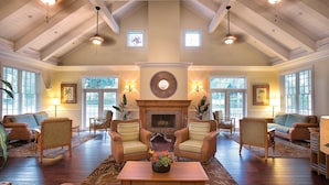 A spacious living room with high ceilings, a fireplace, and multiple seating areas. - WorldMark Orlando - Kingstown Reef (Orlando)