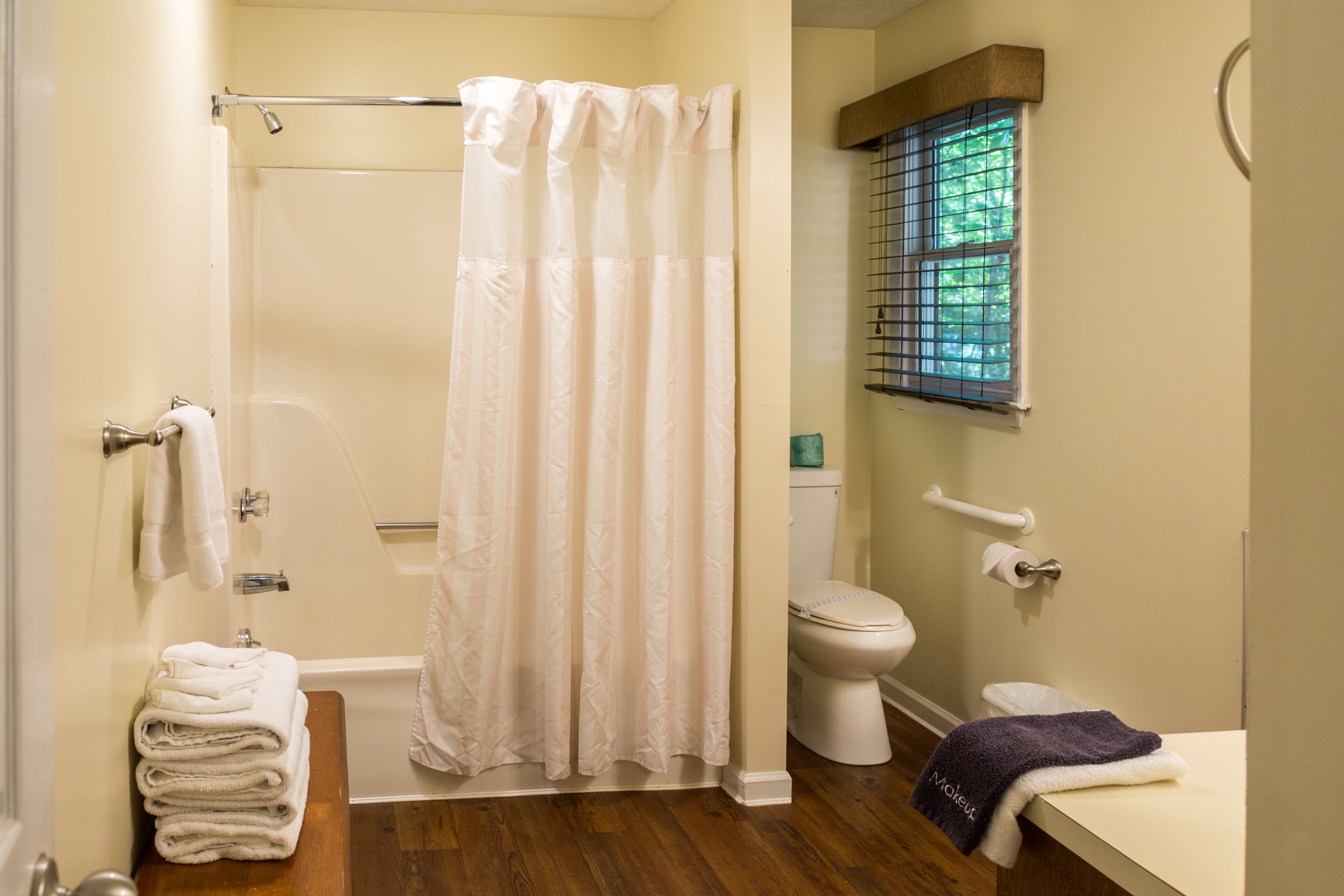 A bathroom with a shower, toilet, and sink.