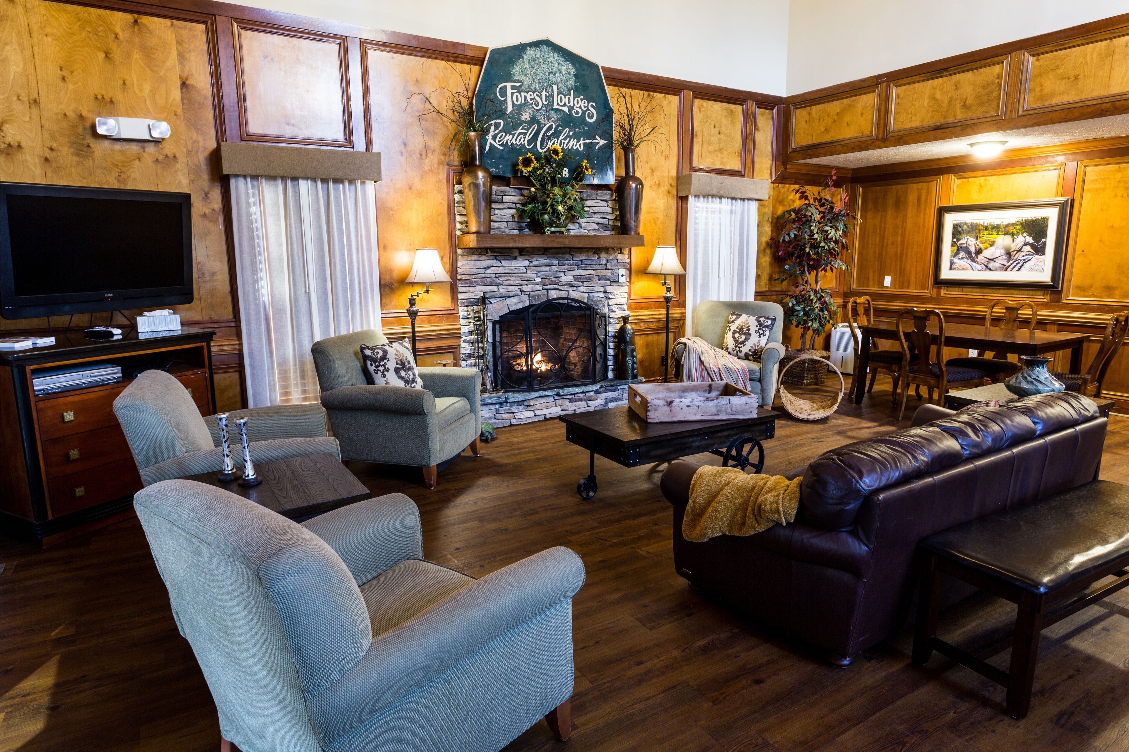 A cozy living room with a fireplace, comfortable seating, and a television.