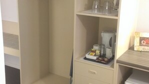 Un dressing avec espace pour suspendre les vêtements, des étagères et des tiroirs.