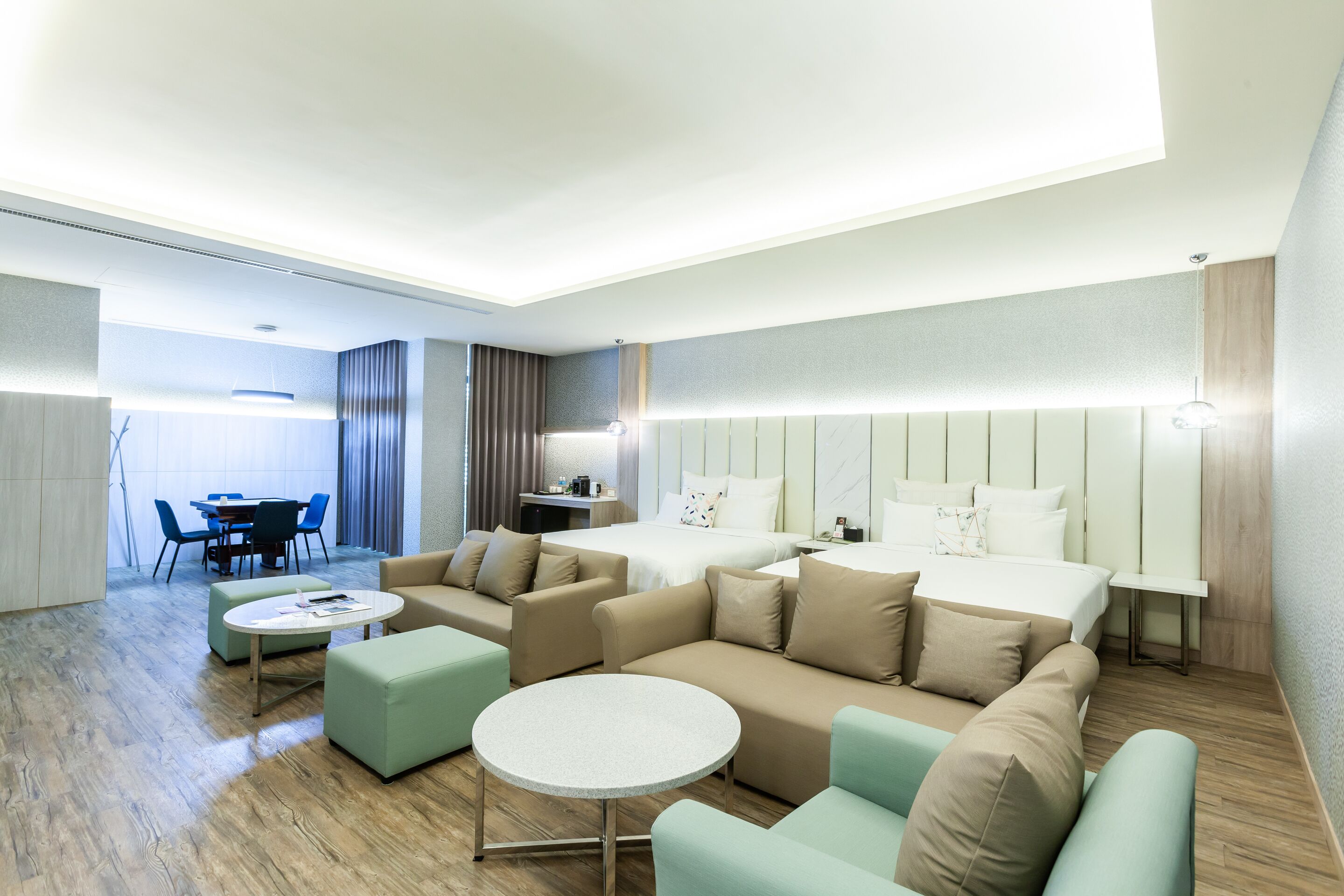 Deluxe Quadruple Room | Living area | 55-inch LED TV with cable channels, TV