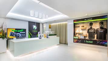 Welcome to our reception area, featuring a digital display, coffee machine, and a large screen showcasing our branding.