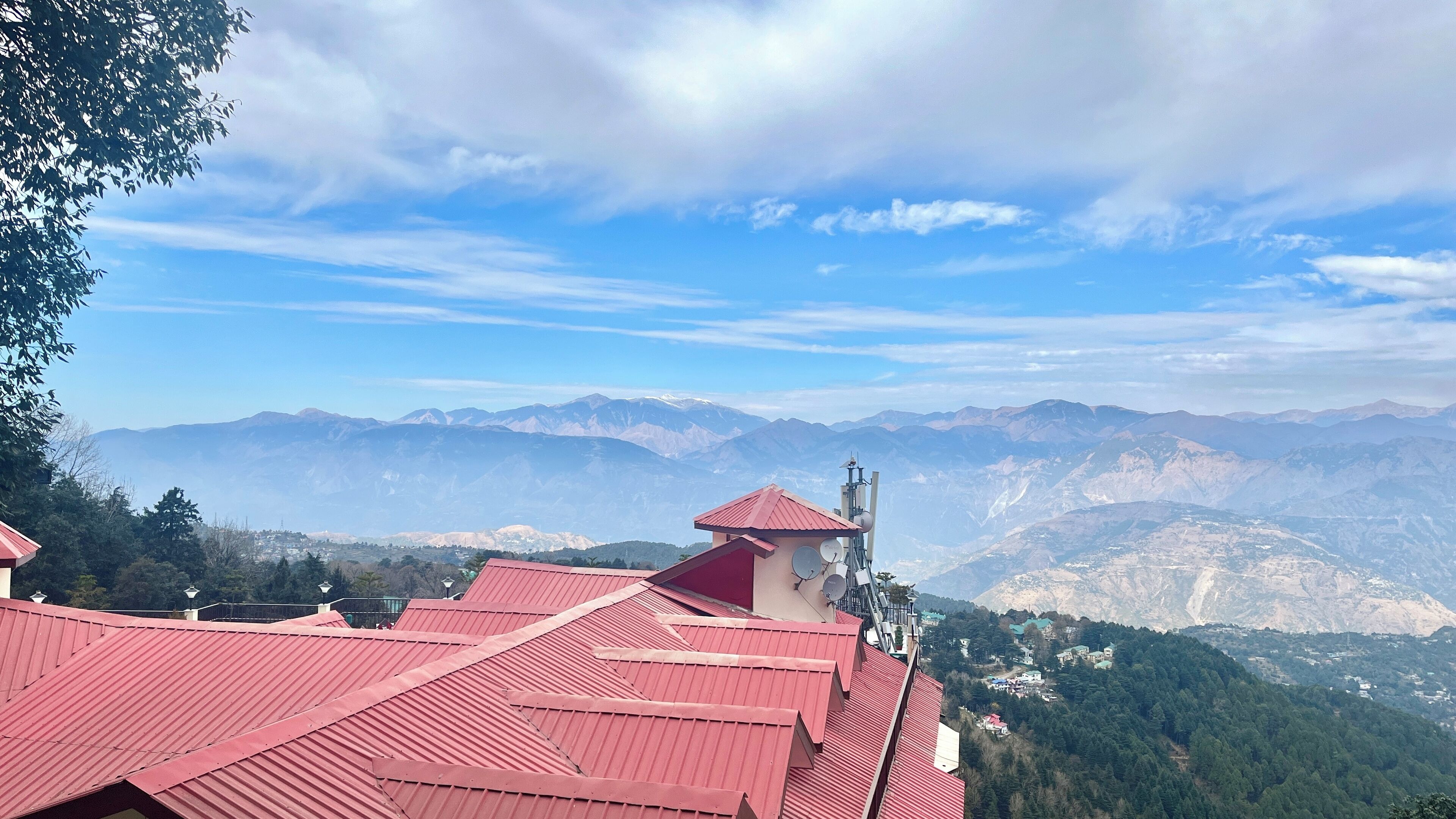 A mountain view with red-roofed buildings and a clear sky.