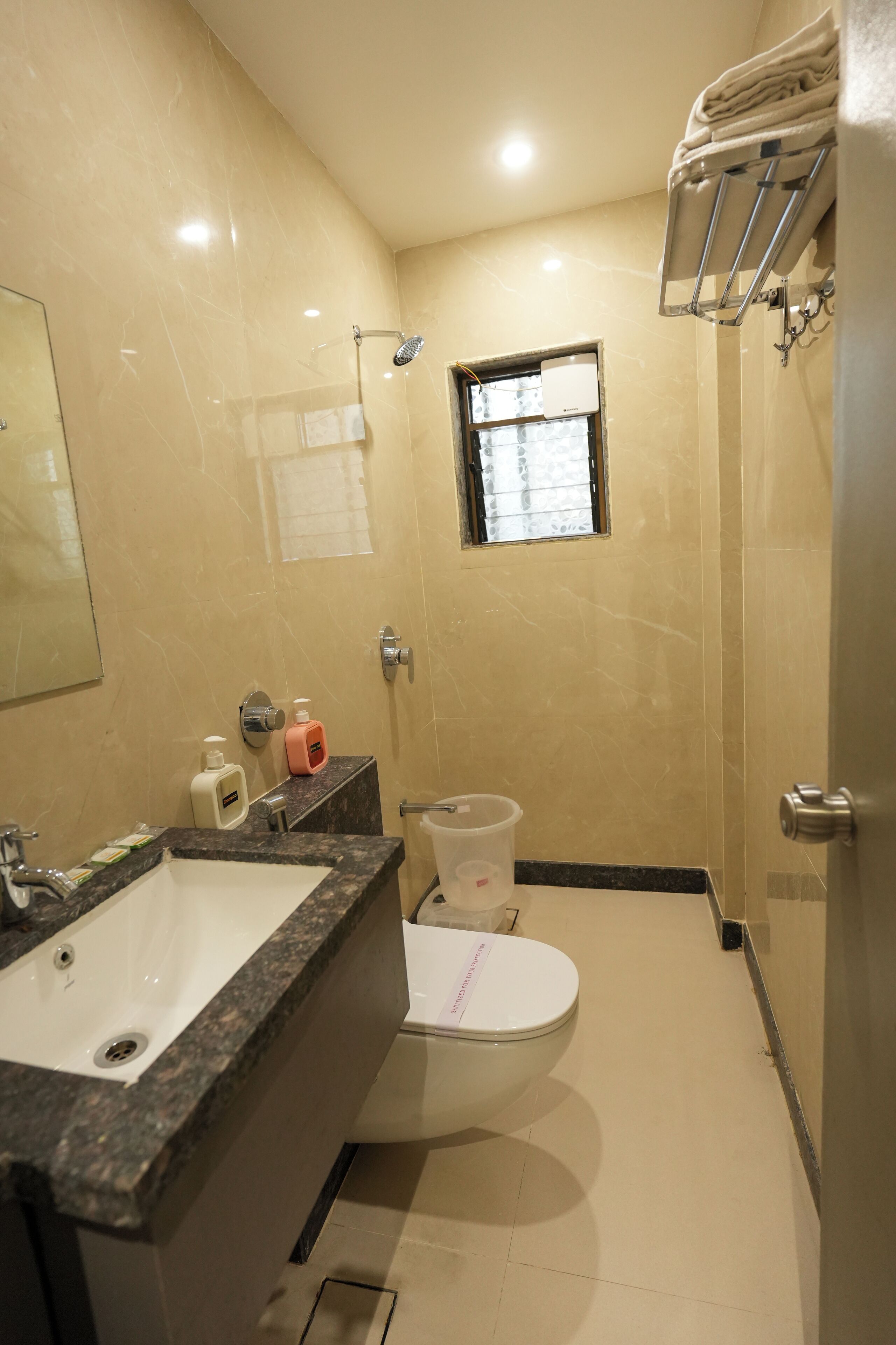 A bathroom with a sink, toilet, and shower.