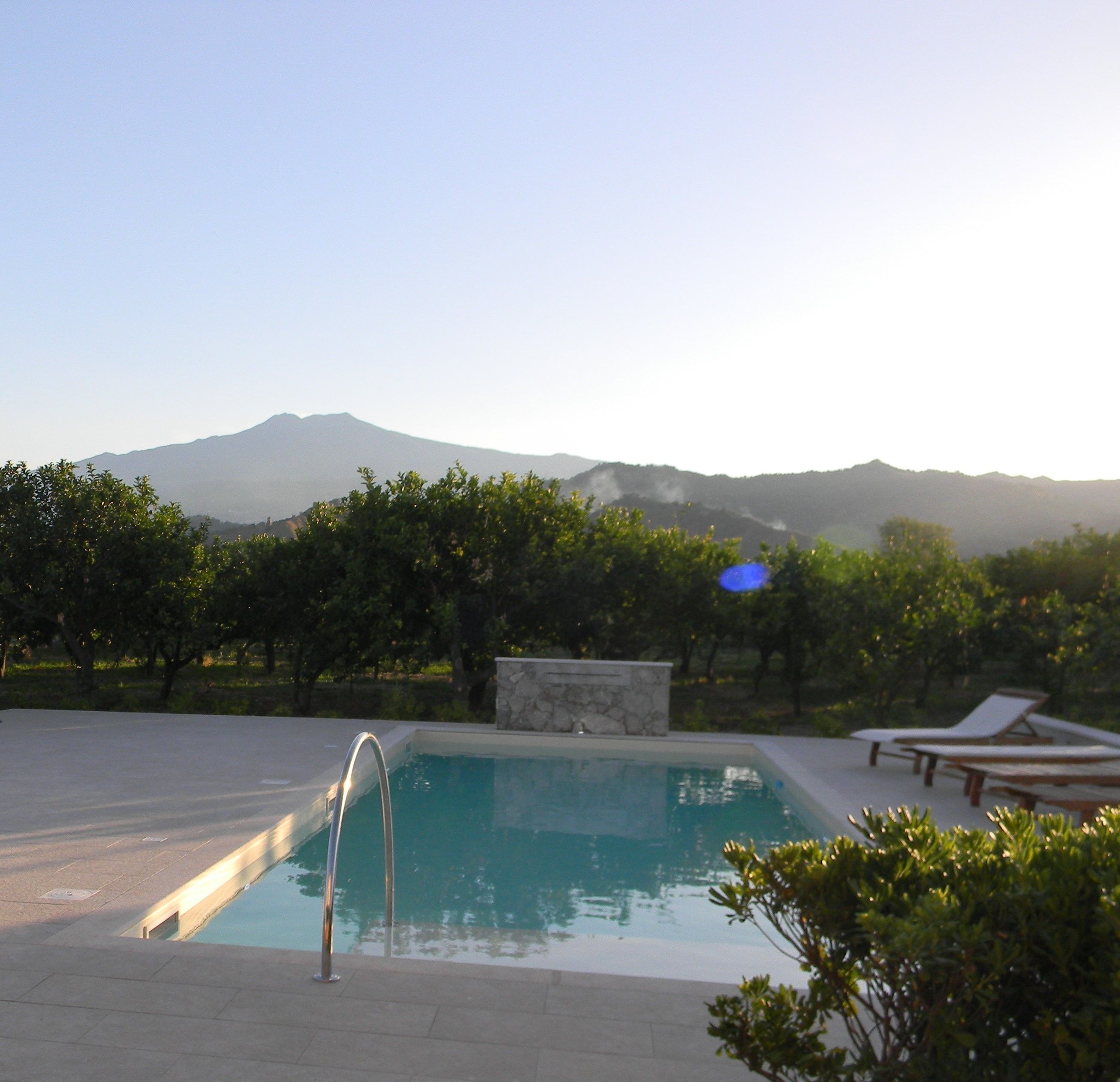 A swimming pool with a view of mountains in the background.