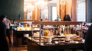 A buffet area with various food items and a Christmas tree. - Shahdag Hotel & Spa (Qusar)