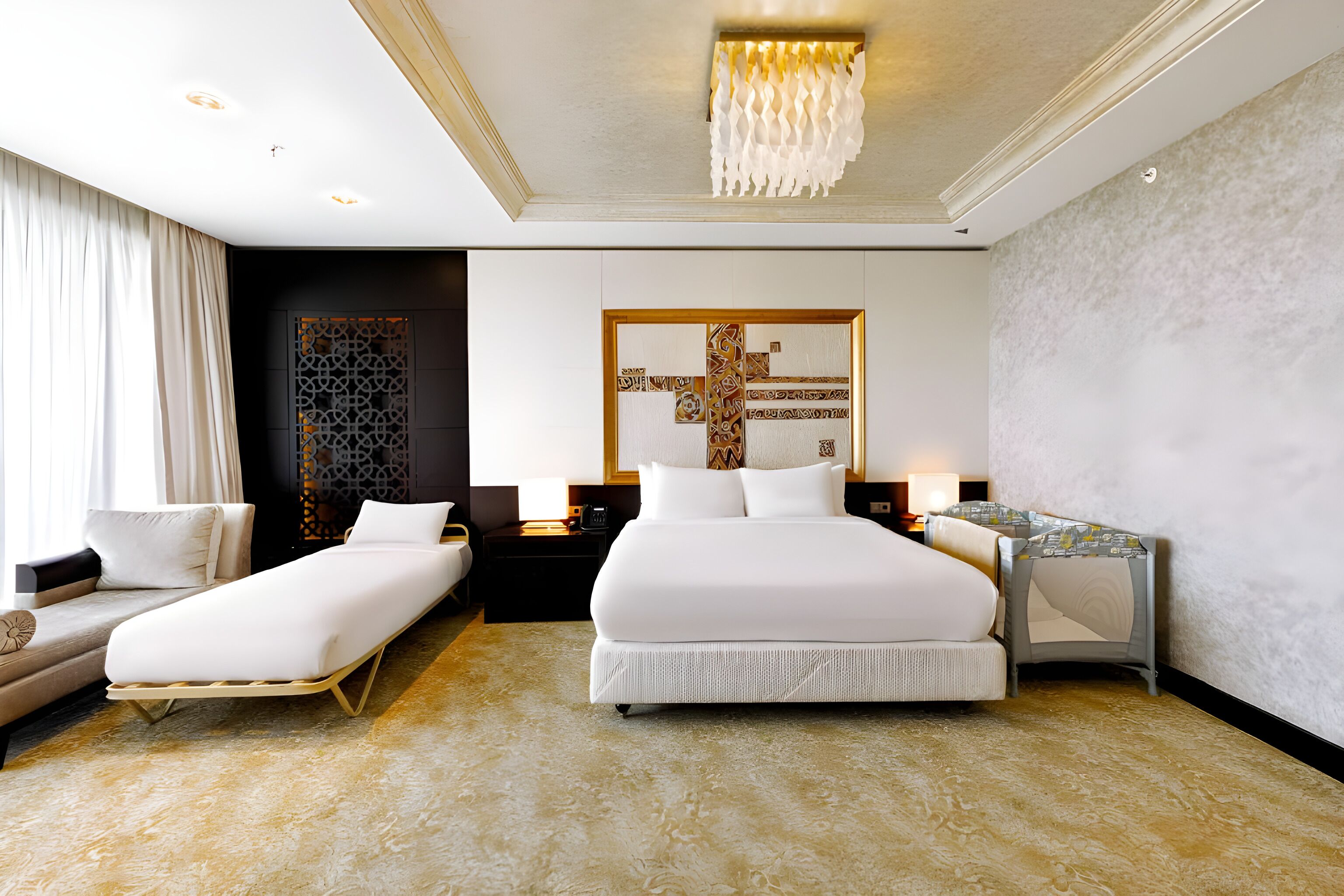 A modern hotel room with two beds, a sofa, a desk, and a decorative wall piece.
