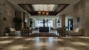 A spacious lobby with a central reception desk, multiple seating areas, and large windows allowing natural light. - Shahdag Hotel & Spa (Qusar)