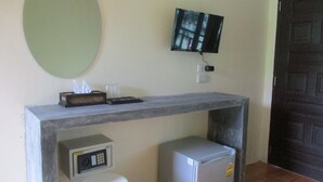 A small kitchenette with a microwave, refrigerator, and a flat-screen TV mounted on the wall. - Phi Phi Green House (Ko Phi Phi)